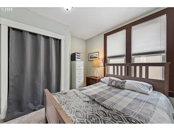 a bedroom with a bed and a window