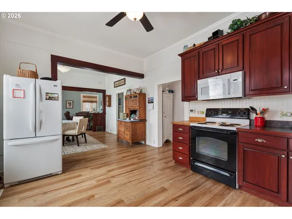 a kitchen with stainless steel appliances granite countertop a refrigerator stove and sink