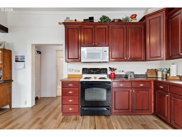 a kitchen with stainless steel appliances granite countertop a stove and wooden cabinets