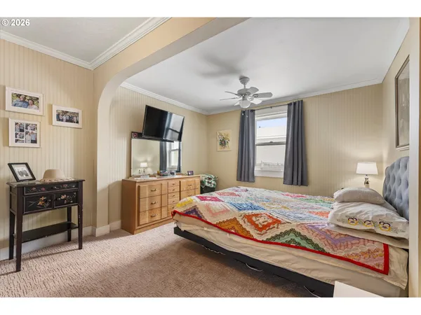 a bedroom with a bed and a desk