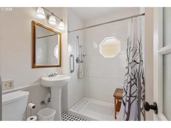 a bathroom with a sink mirror and vanity