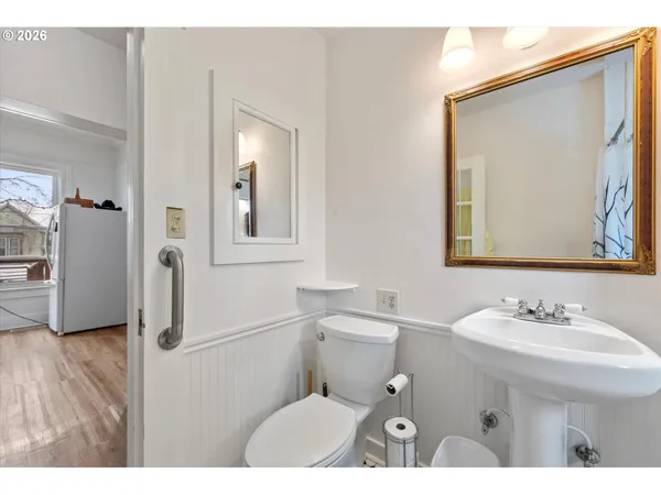 a bathroom with a sink vanity mirror and toilet