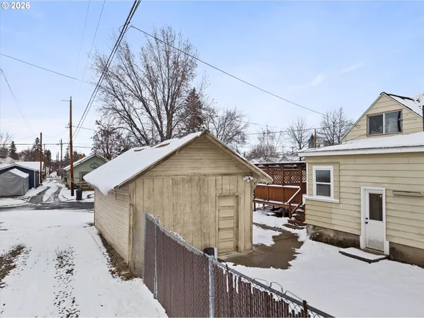a view of a house with wooden fence
