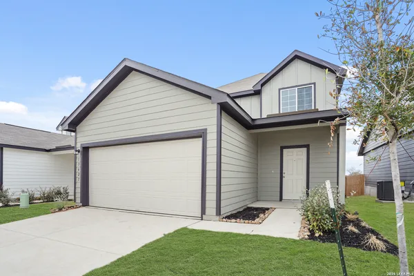 a view of front of a house with a yard and garage
