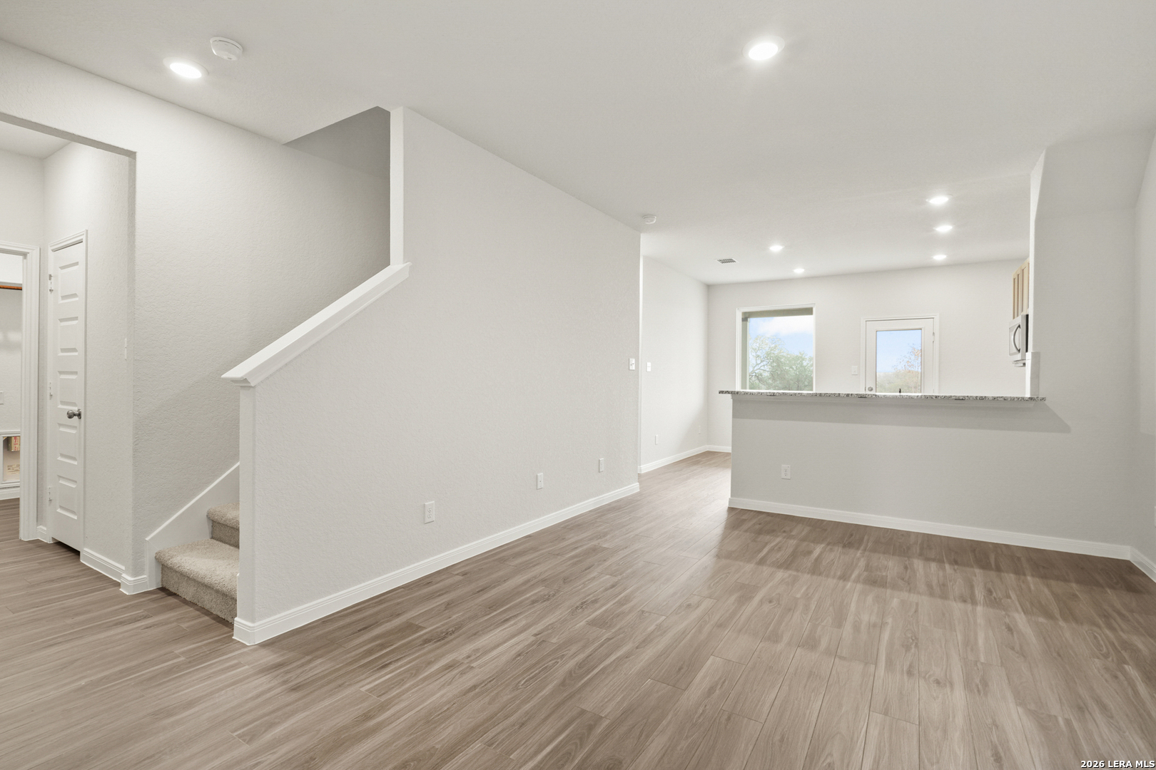 13627 Helton Pass St. Hedwig, TX 78152 - Photo 4 of 33 an empty room with wooden floor and windows