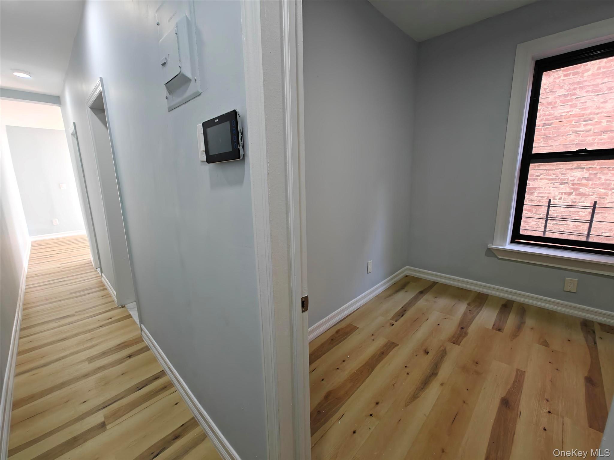 30 Macombs Place, Unit 44 Manhattan, NY 10039 - Photo 4 of 11 a view of empty room with window and wooden floor
