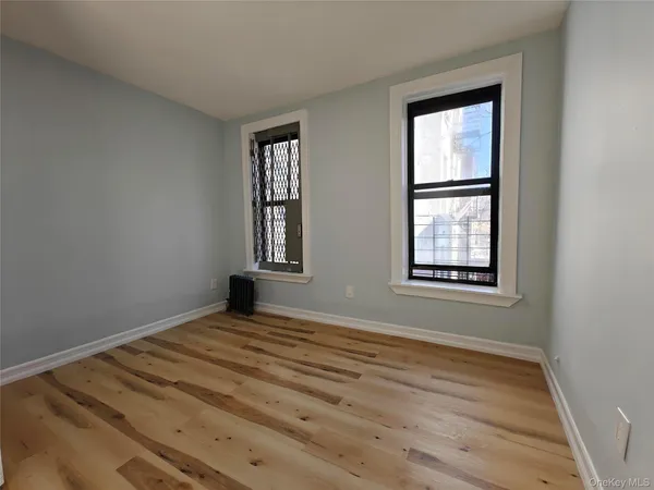 a view of a room with wooden floor and windows