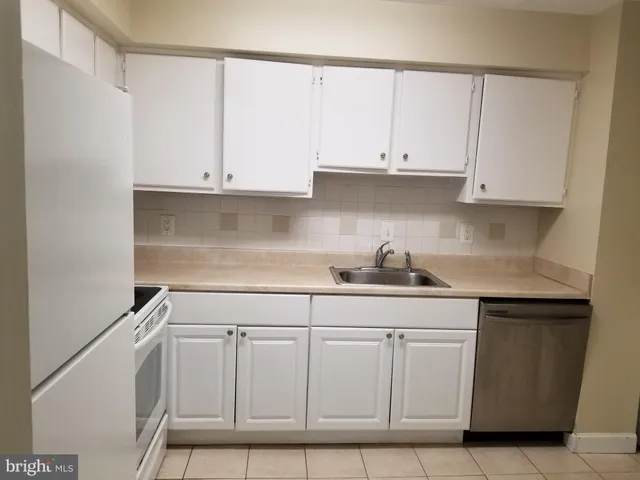 a kitchen with white cabinets