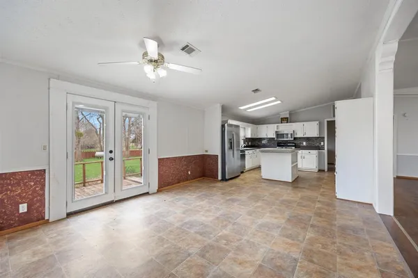 a living room with furniture and kitchen view