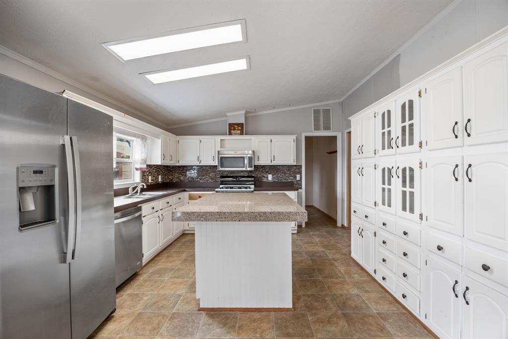 364 Rs County Road 4530 Point, TX 75472 - Photo 17 of 31 a kitchen with stainless steel appliances granite countertop a refrigerator and a stove top oven