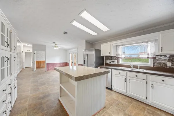 a kitchen with sink cabinets and window