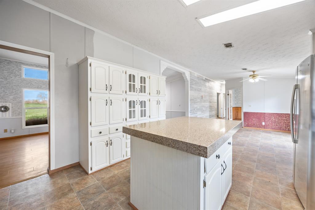 364 Rs County Road 4530 Point, TX 75472 - Photo 19 of 31 a kitchen with granite countertop a sink and a refrigerator