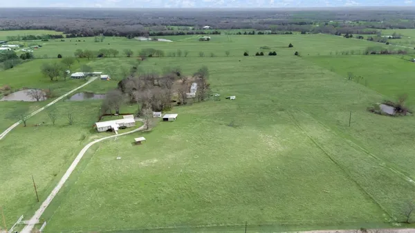 a view of a green field with clear sky