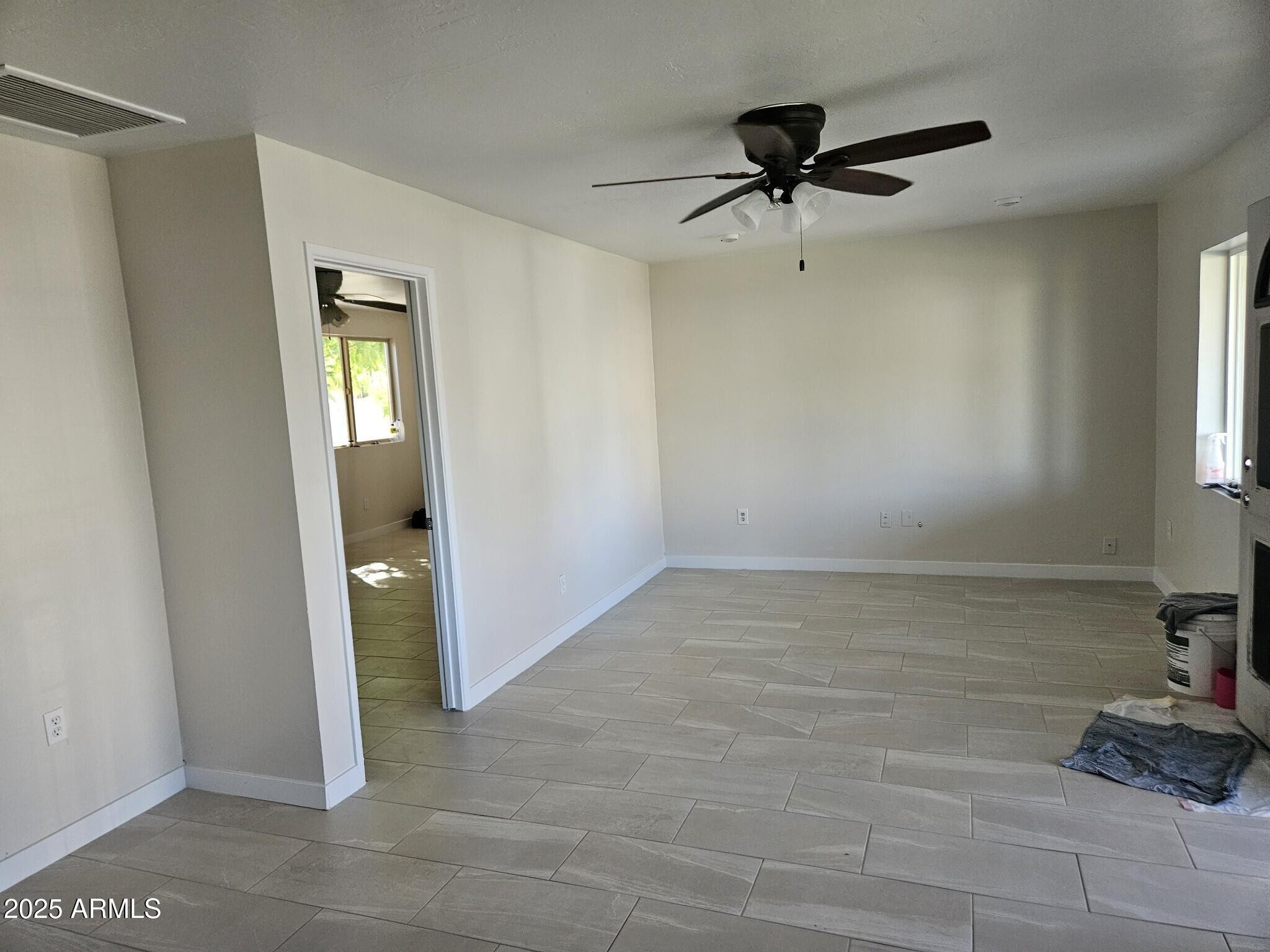 819 East Apollo Road Phoenix, AZ 85042 - Photo 7 of 17 a view of a livingroom with a ceiling fan and window