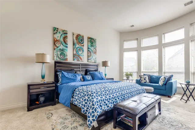 a bedroom with a bed and a couch