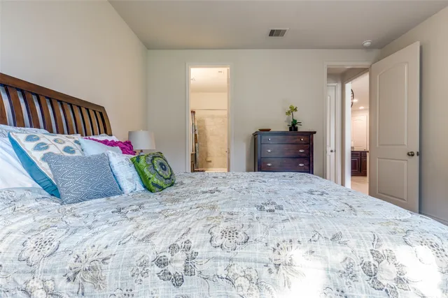 a bedroom with a bed and a dresser