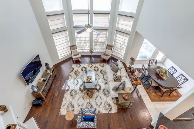 walk in closet with wooden floor and windows