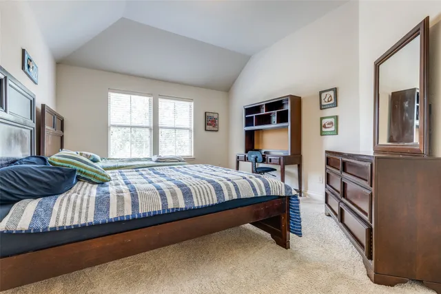 a bedroom with a bed and a night stand