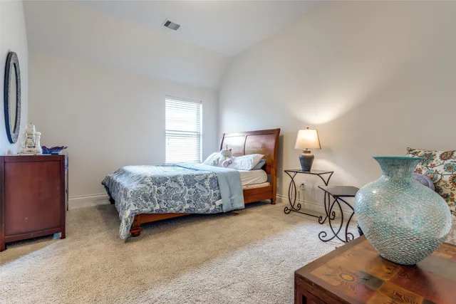 a bedroom with bed and a couch