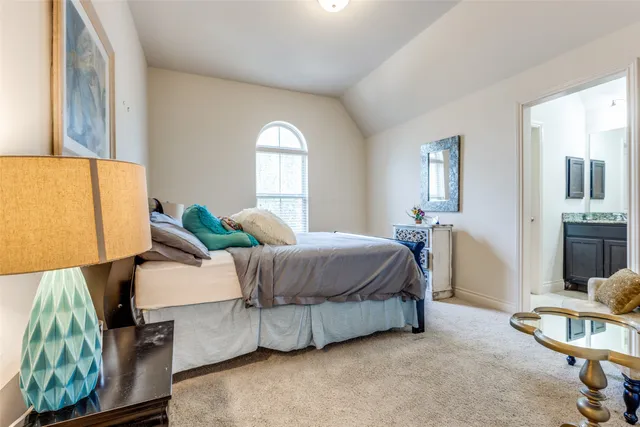 a spacious bedroom with a bed and window
