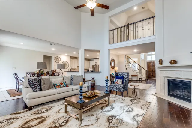 a living room with furniture a fireplace and a chandelier