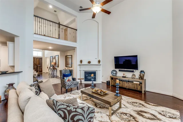 a living room with furniture a flat screen tv and a fireplace