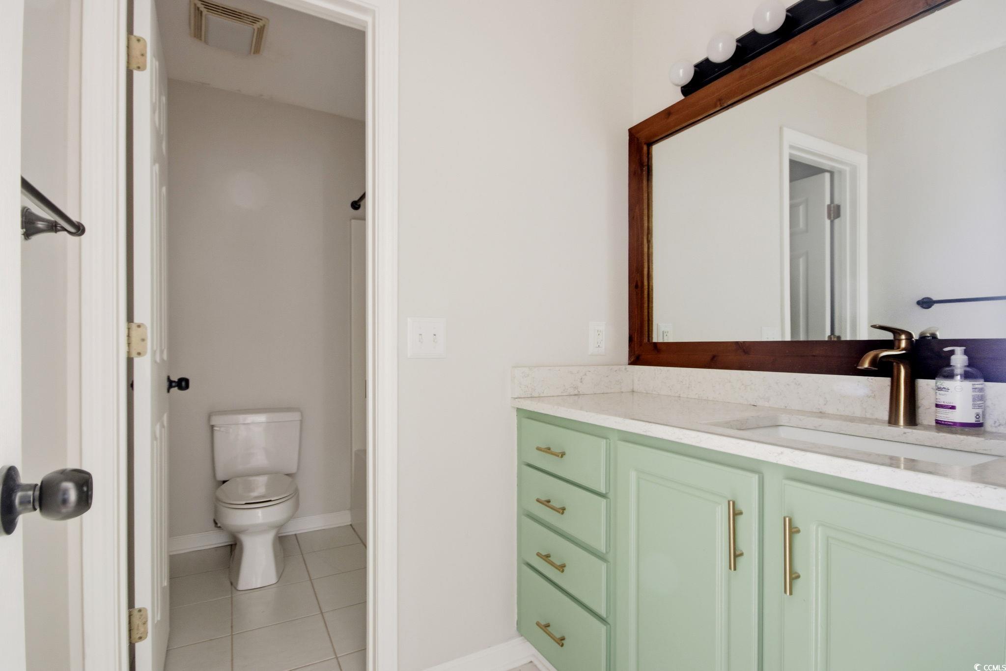 1735 Rice Street Georgetown, SC 29440 - Photo 18 of 34 Bathroom with vanity, a shower with shower curtain, and light tile patterned floors