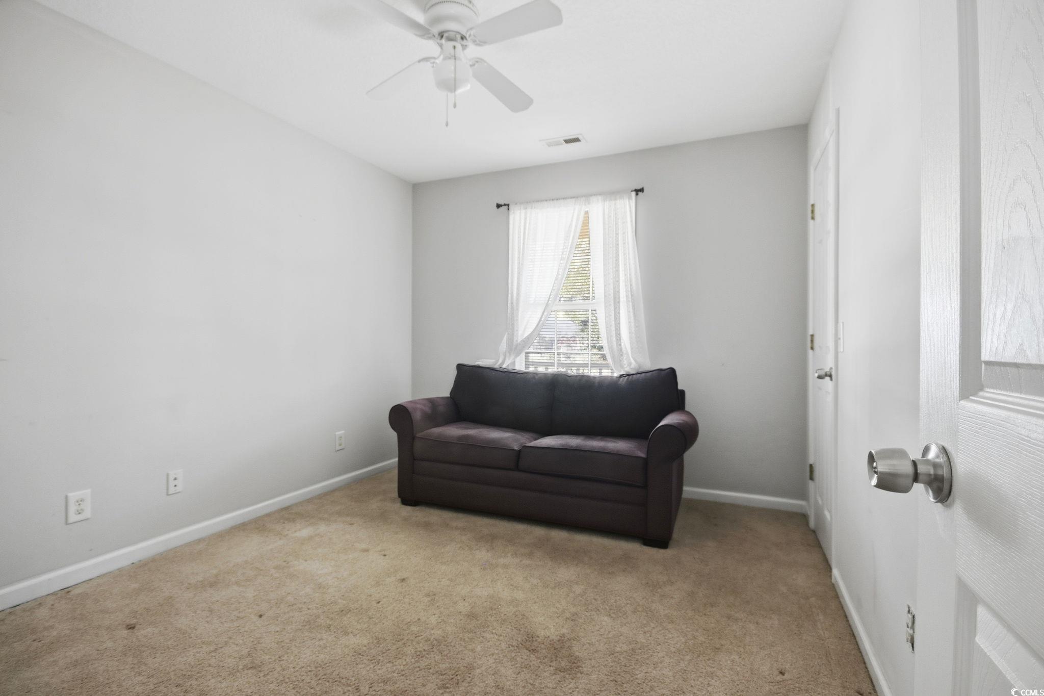 1735 Rice Street Georgetown, SC 29440 - Photo 19 of 34 Living area featuring carpet flooring and ceiling fan