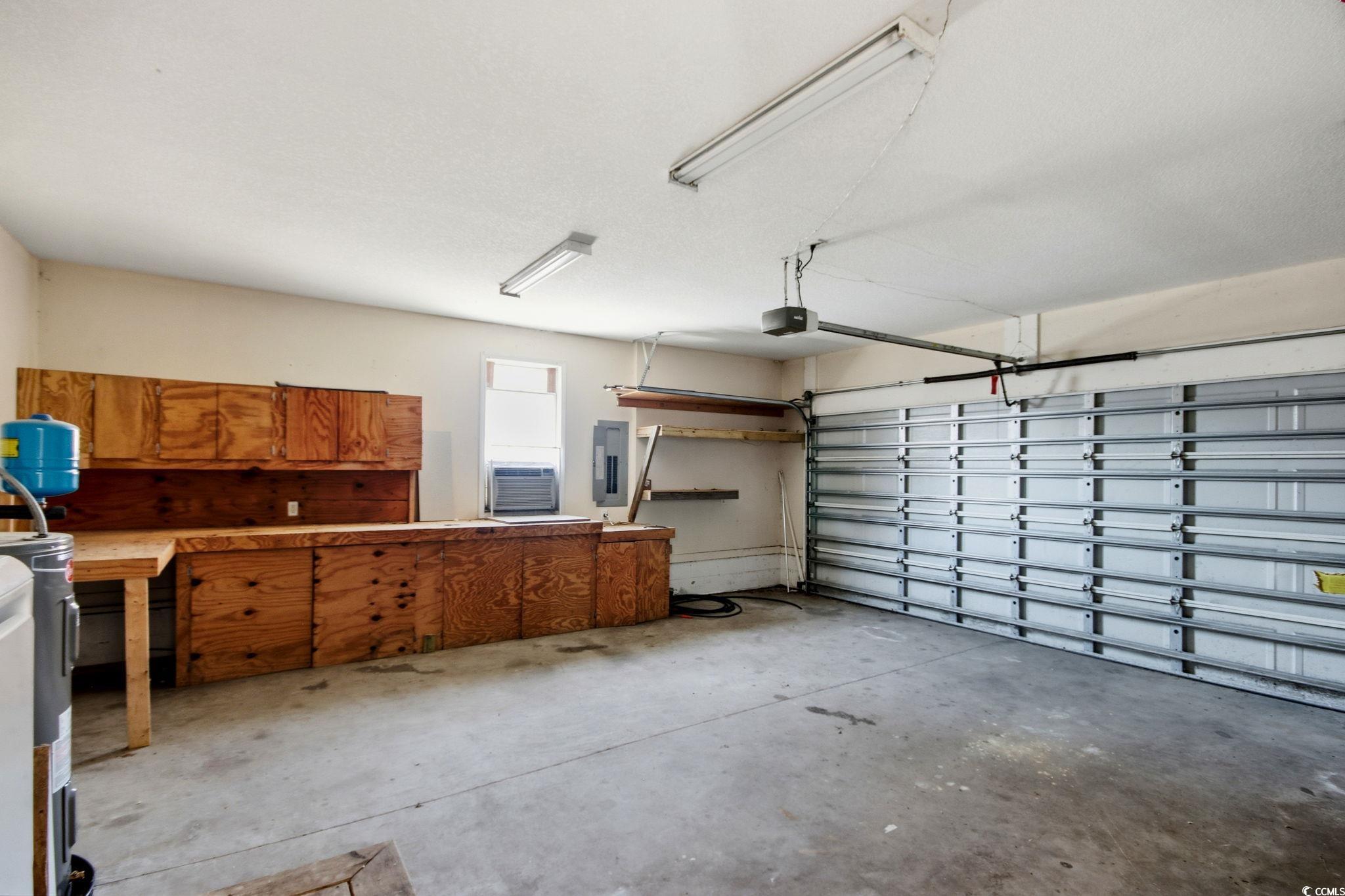 1735 Rice Street Georgetown, SC 29440 - Photo 25 of 34 Garage featuring electric panel and cooling unit