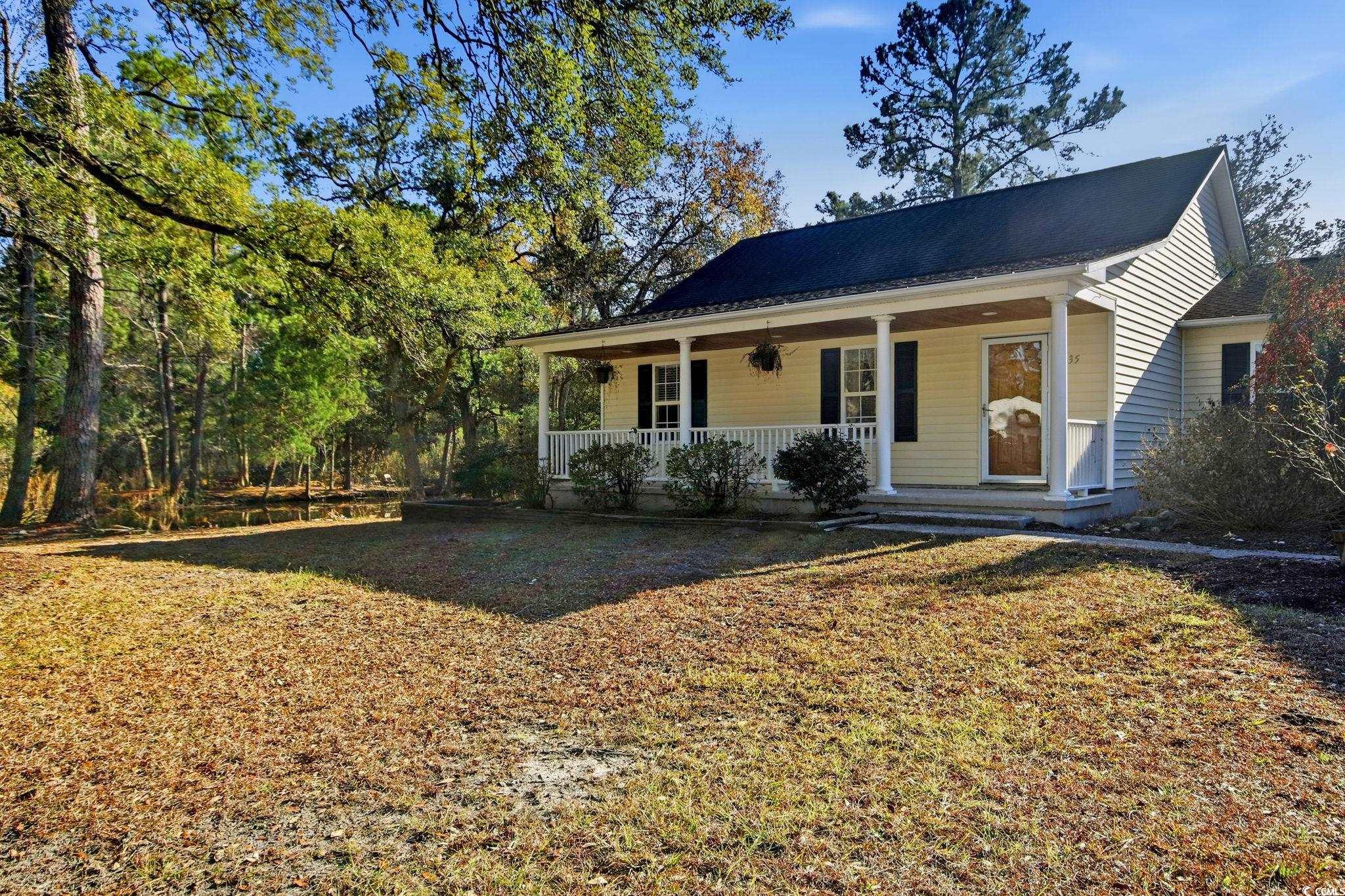 1735 Rice Street Georgetown, SC 29440 - Photo 26 of 34 View of front facade featuring covered porch and a front yard