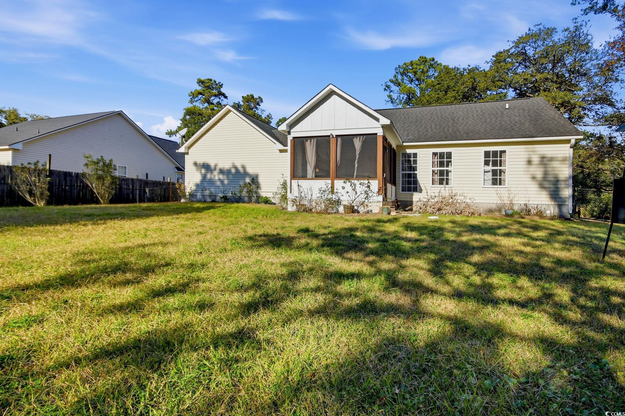 1735 Rice Street Georgetown, SC 29440 - Photo 28 of 34 Rear view of property with a sunroom and roof with shingles