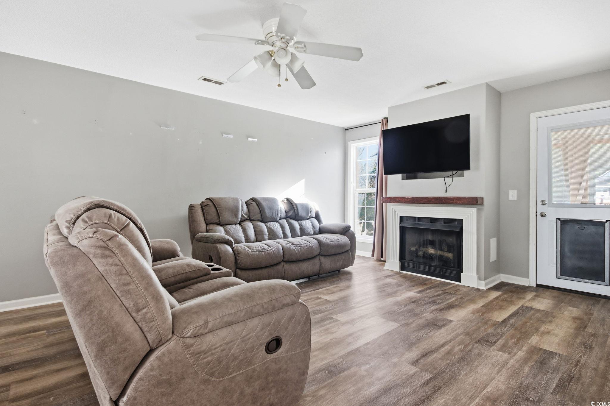 1735 Rice Street Georgetown, SC 29440 - Photo 10 of 34 Living room featuring dark wood finished floors, a fireplace, and ceiling fan