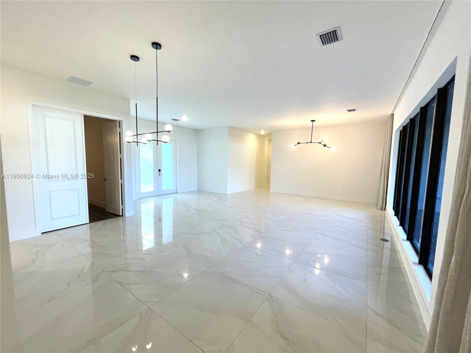 11181 Southwest 92nd Avenue, Unit 11181 Miami, FL 33176 - Photo 20 of 47 a view of a kitchen with a refrigerator and a ceiling fan