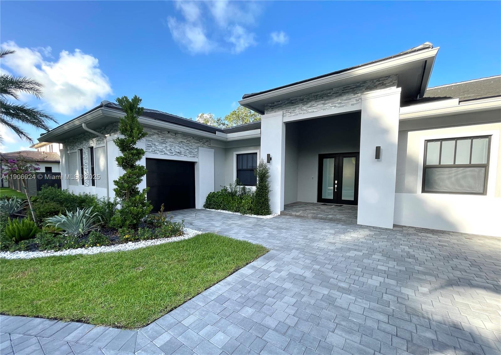 11181 Southwest 92nd Avenue, Unit 11181 Miami, FL 33176 - Photo 2 of 47 a front view of a house with a yard and garage