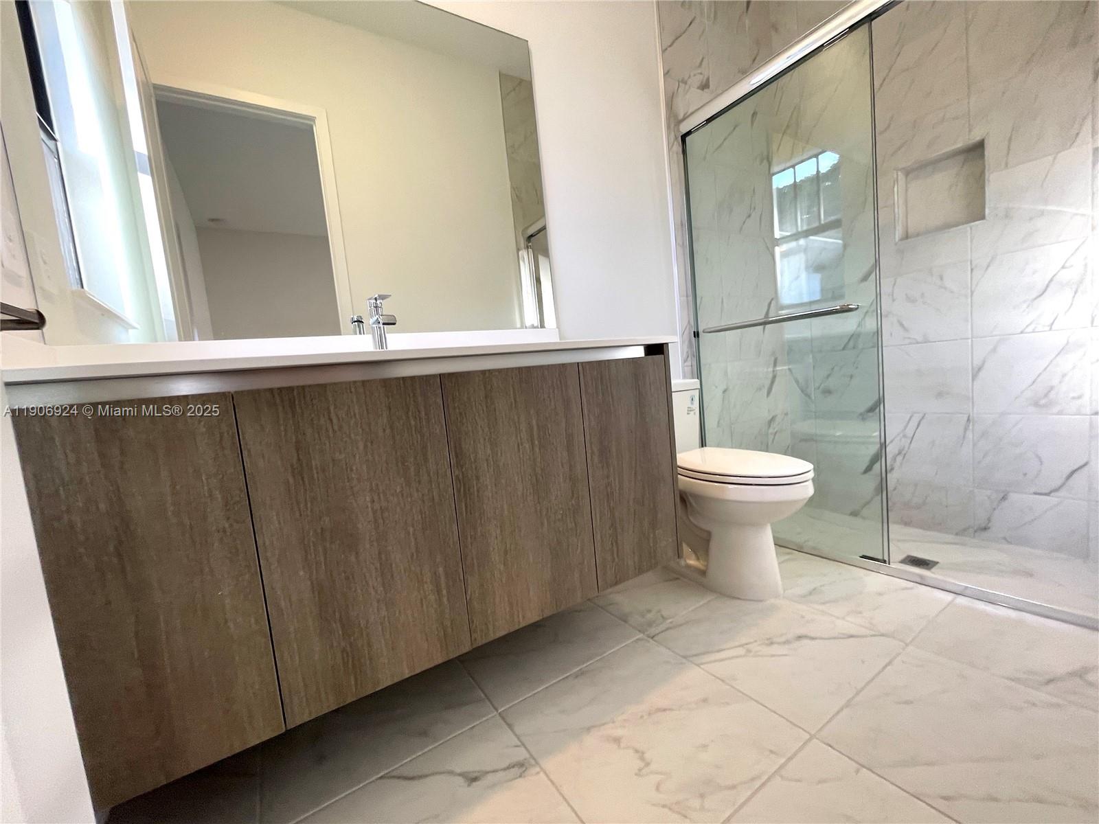 11181 Southwest 92nd Avenue, Unit 11181 Miami, FL 33176 - Photo 47 of 47 a bathroom with a sink toilet and shower