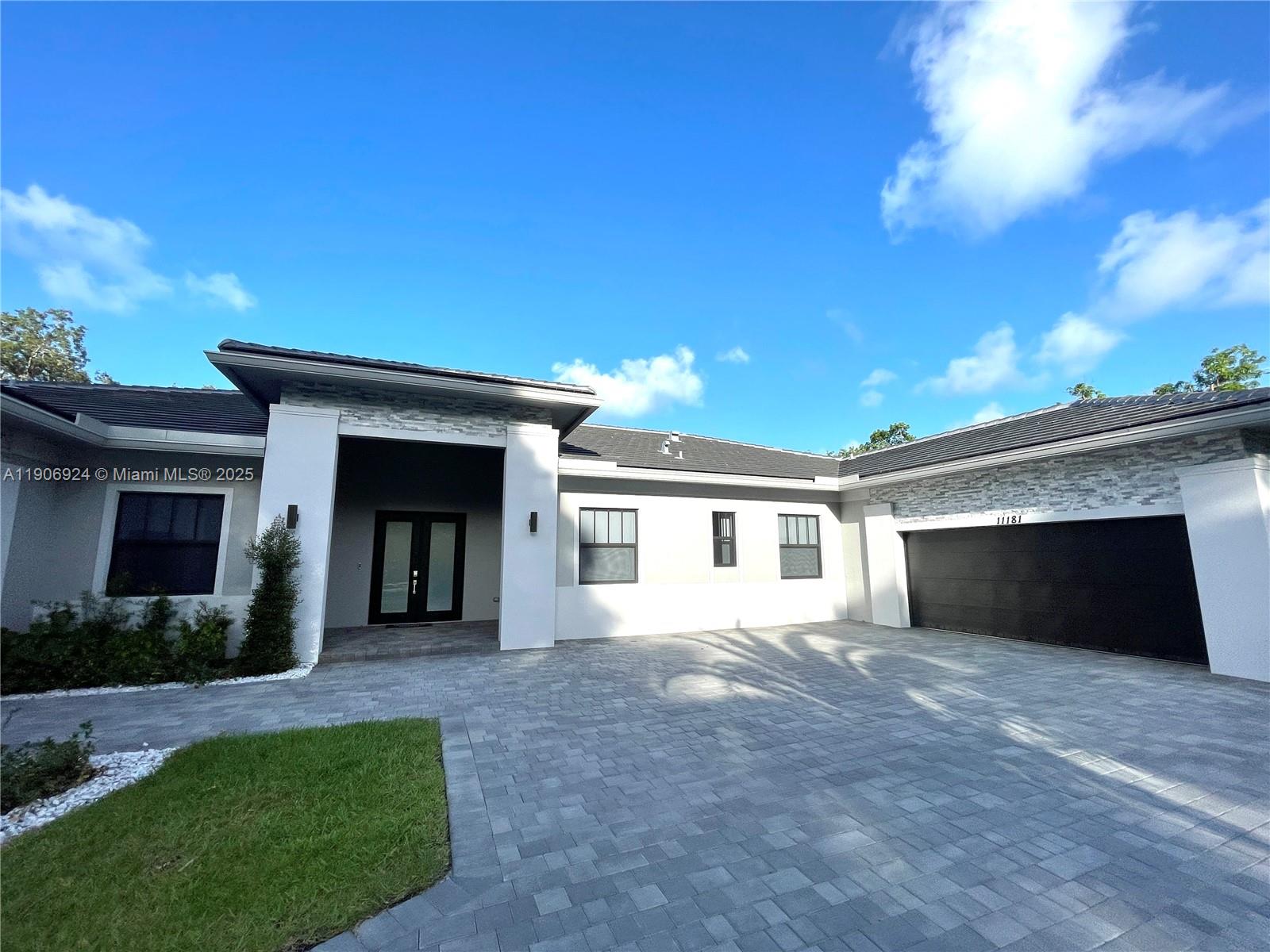 11181 Southwest 92nd Avenue, Unit 11181 Miami, FL 33176 - Photo 6 of 47 a front view of a house with a yard and potted plants