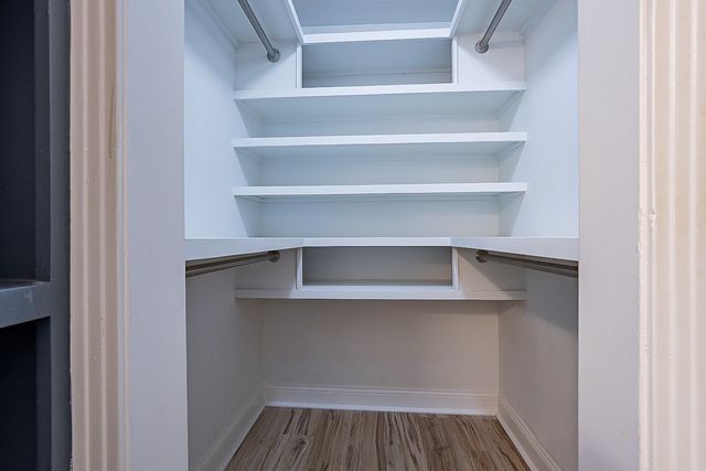 a view of walk in closet with empty racks
