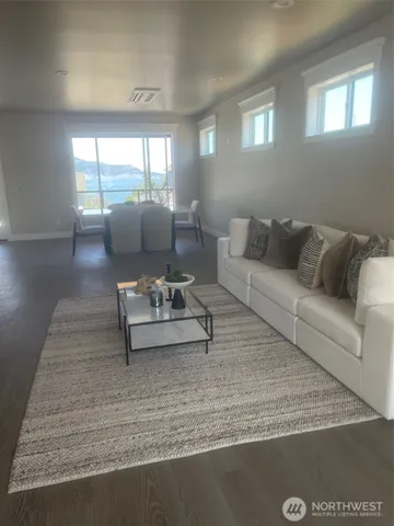 a large white kitchen with white cabinets and stainless steel appliances