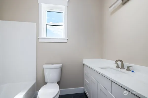 a utility room with cabinets washer and dryer