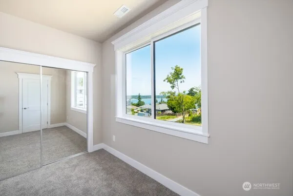 a bathroom with a toilet sink vanity and a mirror