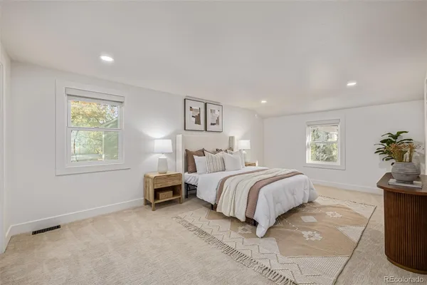 a spacious bedroom with a bed and a couch