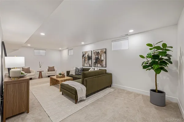 a living room with furniture potted plant and a chandelier