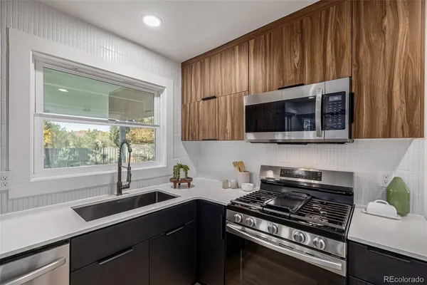 a kitchen with a stove a sink and a microwave