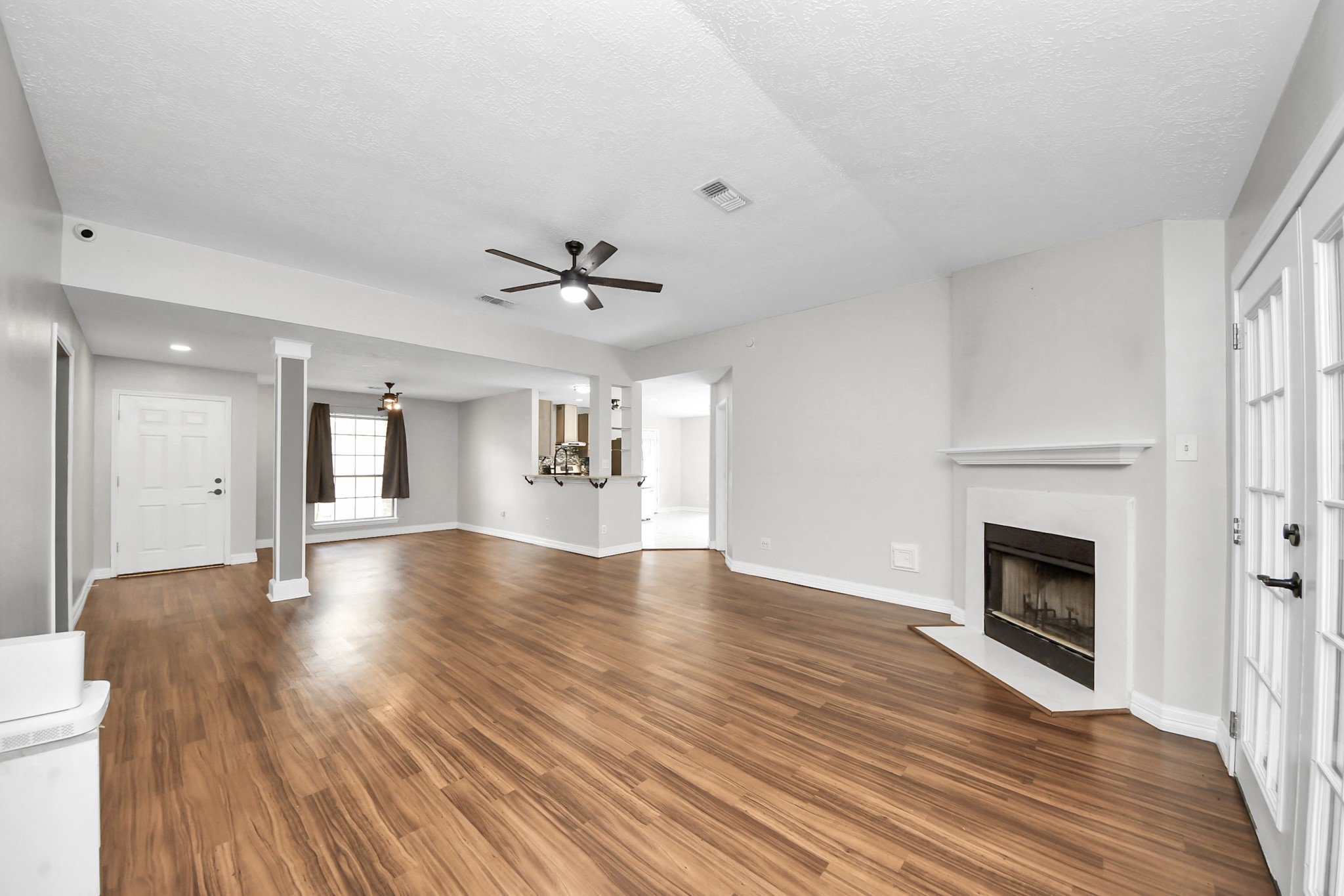 28707 Stapleford Street Spring, TX 77386 - Photo 8 of 38 a view of an empty room with wooden floor and a fireplace