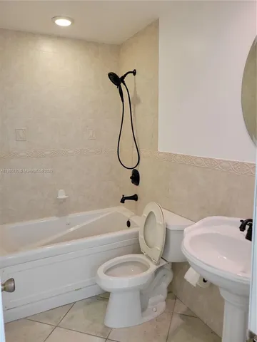 an empty room with windows and ceiling fan