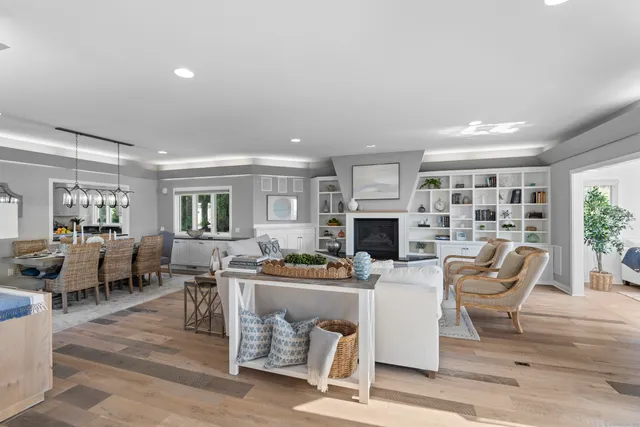 a living room with furniture a fireplace and a large window