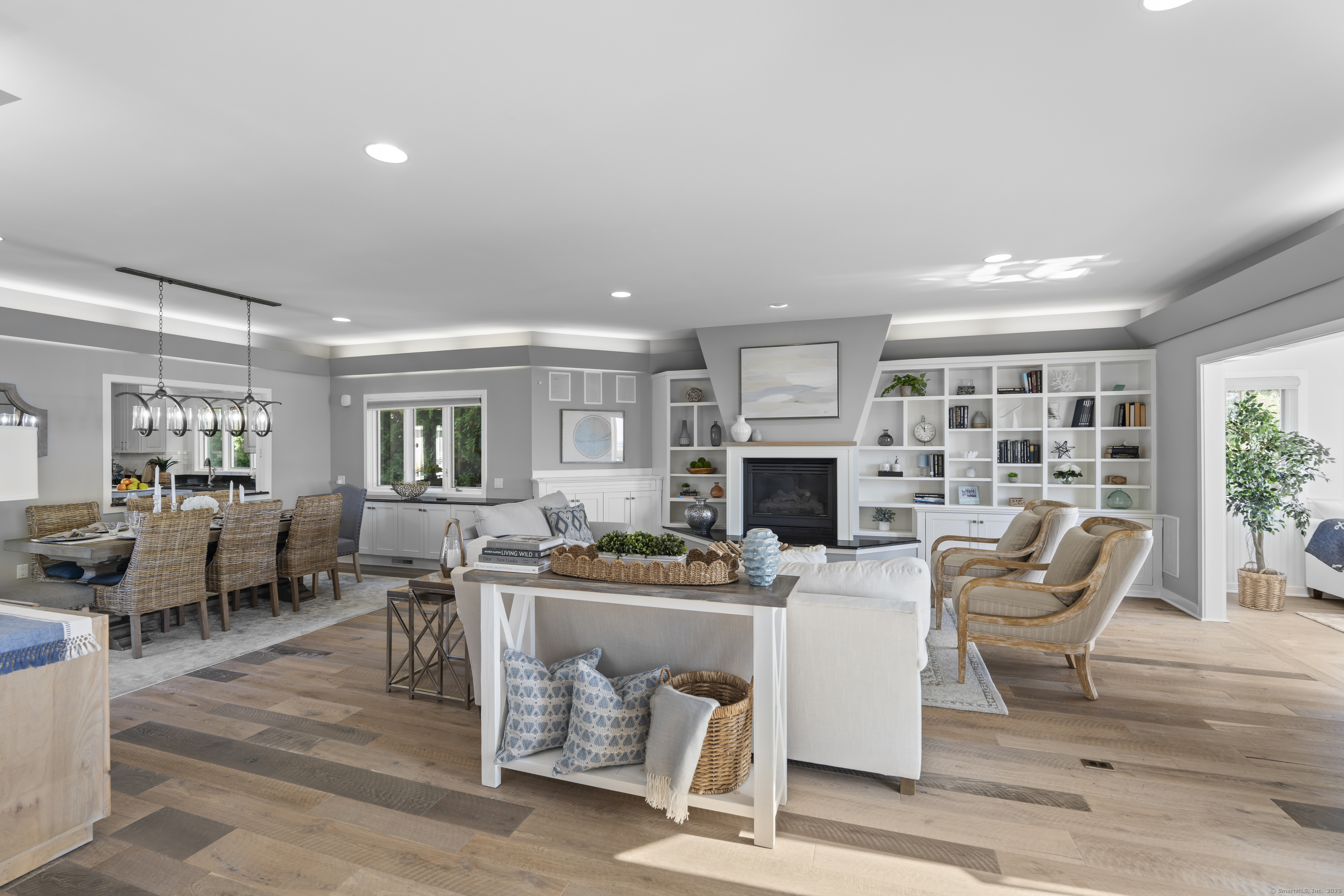 372 Maple Avenue Old Saybrook, CT 06475 - Photo 13 of 40 a living room with furniture a fireplace and a large window