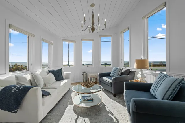 a living room with furniture a chandelier and a chandelier