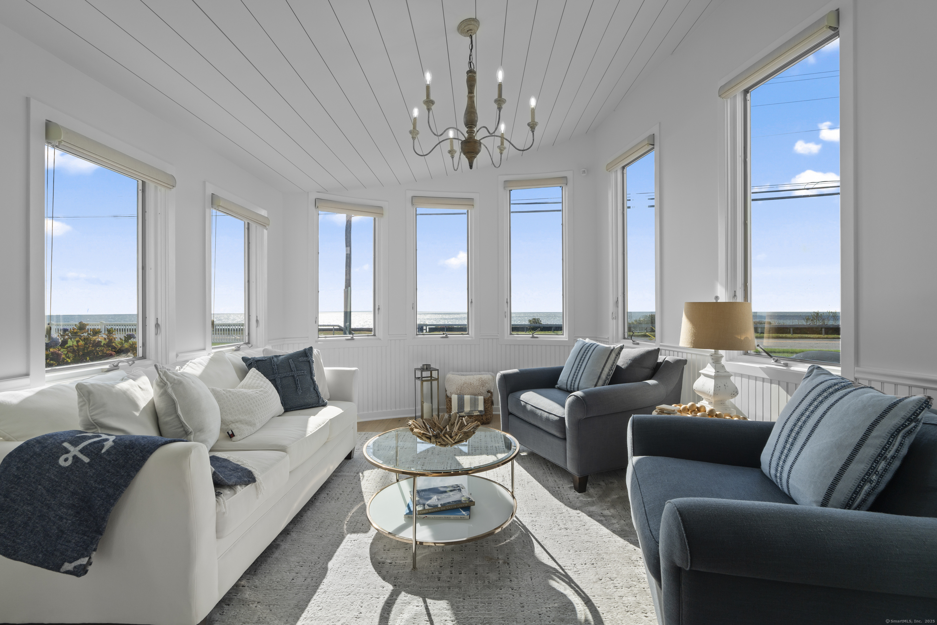 372 Maple Avenue Old Saybrook, CT 06475 - Photo 17 of 40 a living room with furniture a chandelier and a chandelier