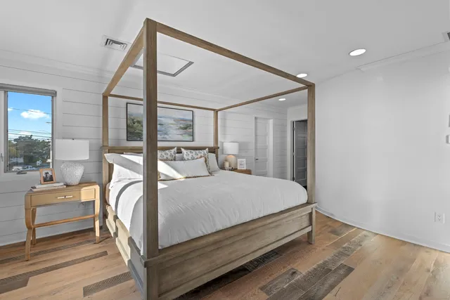 a bed sitting in a bedroom next to a window